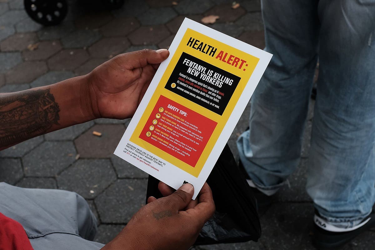 A heroin user reads an alert on fentanyl before being interviewed by John Jay College of Criminal Justice students as part of a project to interview Bronx drug users in order to compile data about overdoses on August 8, 2017 in New York City. (AFP)