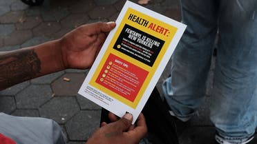A heroin user reads an alert on fentanyl before being interviewed by John Jay College of Criminal Justice students as part of a project to interview Bronx drug users in order to compile data about overdoses on August 8, 2017 in New York City. (AFP)
