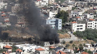Smoke billows from a building in the Jenin refugee camp on May 13, 2022 during an Israeli military raid. Israel was bolstering security forces in Jerusalem ahead of veteran Al Jazeera journalist Shireen Abu Akleh's funeral, two days after she was killed during an Israeli army raid. (AFP)