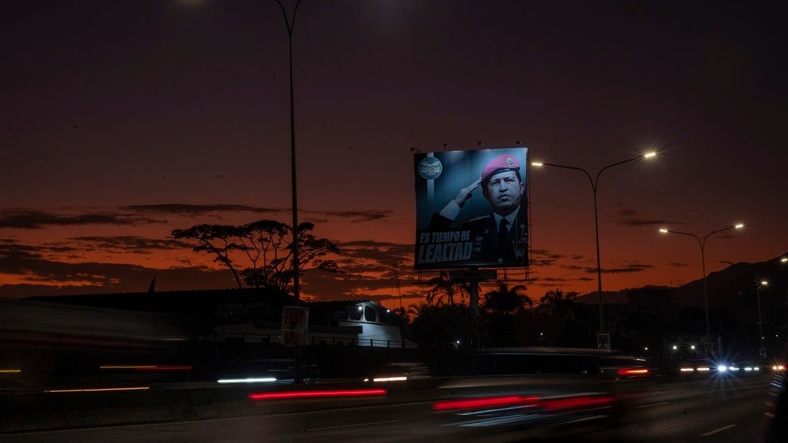 Cars drive past a billboard depicting late Venezuelan leader (1999-2013) Hugo Chavez, reading “It’s time for loyalty” at the Francisco Fajardo highway in Caracas, on April 12, 2022. (AFP)