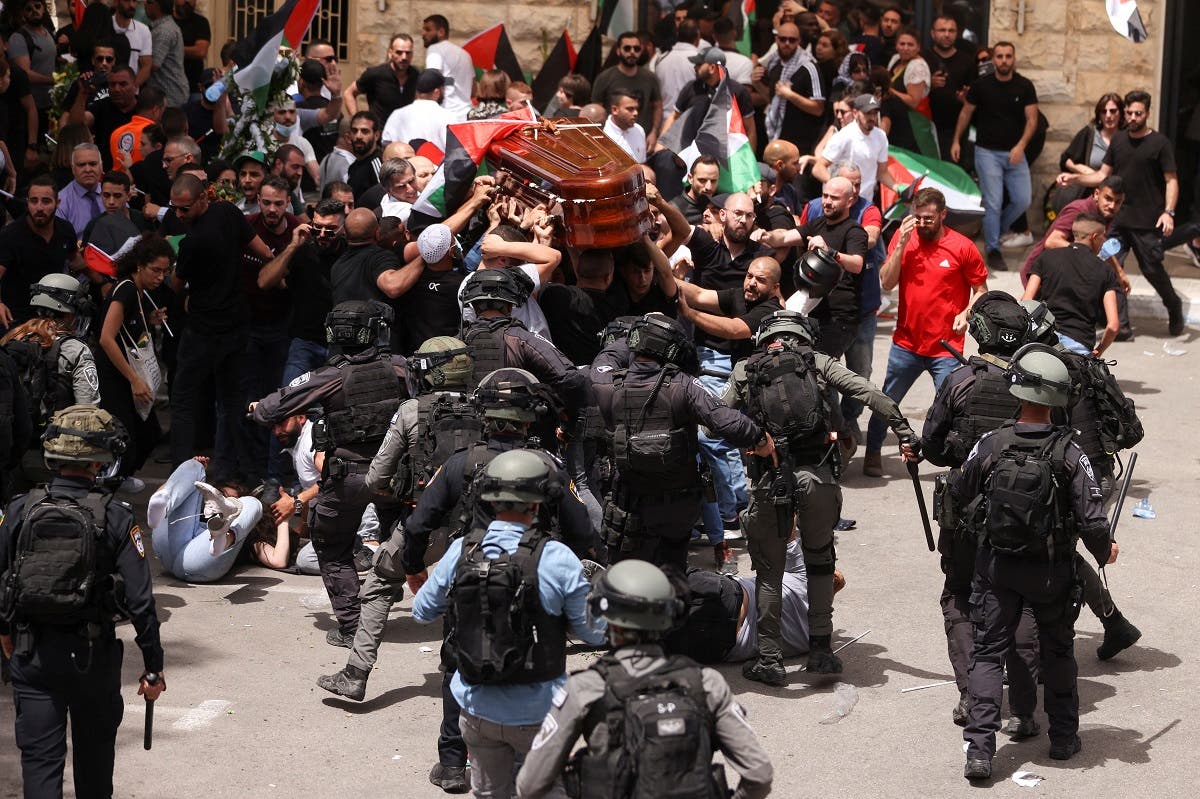 Israeli forces attack Palestinians as they carry the coffin of Palestinian-American Shireen Abu Akleh in Jerusalem on May 13, 2022. (Reuters)