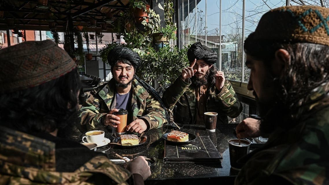 A file photo shows Taliban fighters sit with their snacks at a restaurant in Kabul on December 31, 2021. (AFP)