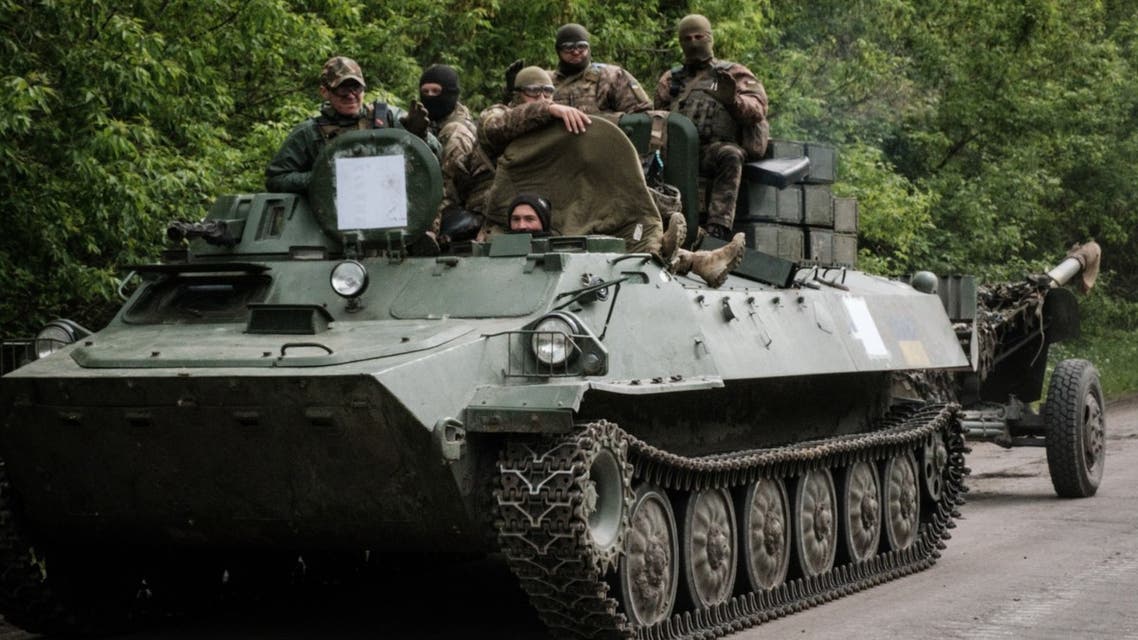 Ukrainian soldiers stand on a multipurpose light armoured towing vehicle near Bakhmut, eastern Ukraine, on May 15, 2022, amid the Russian invasion of Ukraine. (AFP)