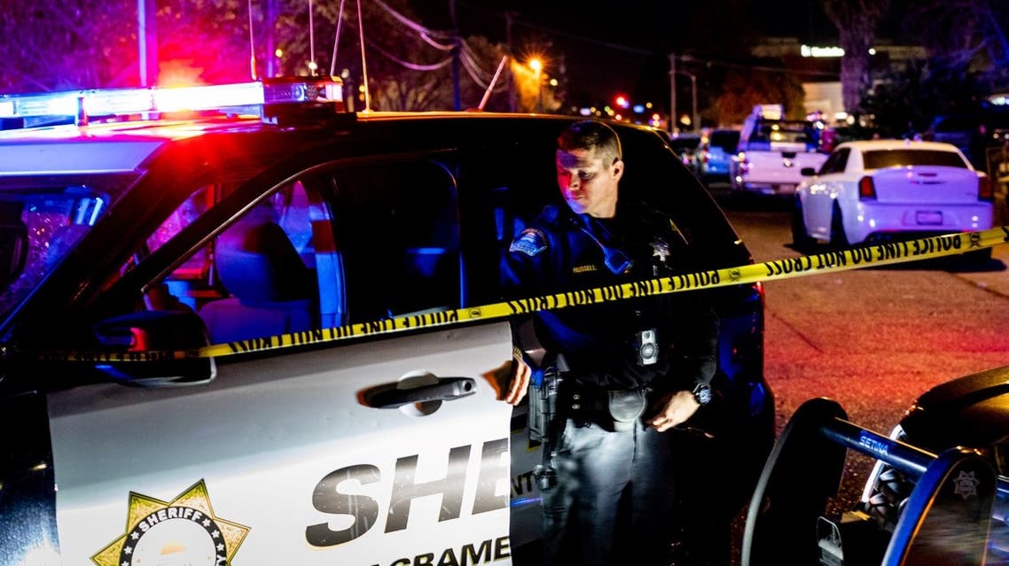 n this file photo taken on February 28, 2022 a Sacramento County Sheriff's Department officer looks on near the crime scene outside a church where a man shot dead four people, including three of his children, before turning the gun on himself in Sacramento, California. (AFP)