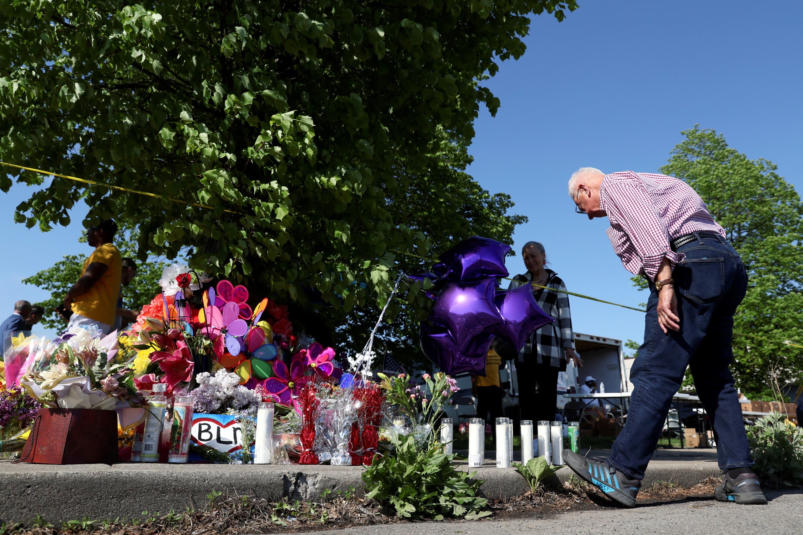 A man looks a memorial for victims near the scene of a shooting at a TOPS supermarket in Buffalo, New York, US May 15, 2022. (Reuters)