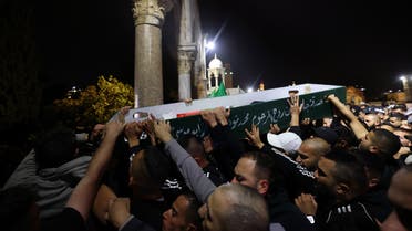 Palestinian mourners carry the body of Walid al-Sharif, 23, who died of wounds suffered last month during clashes with Israeli police at Jerusalem's flashpoint al-Aqsa mosque compound, on May 16, 2022 at the al-Aqsa compound. Sharif, 23, was taken to Hadassah Ein Kerem hospital with a head injury on April 22 and he was pronounced dead this morning, the hospital said in a statement. (Photo by AHMAD GHARABLI / AFP)