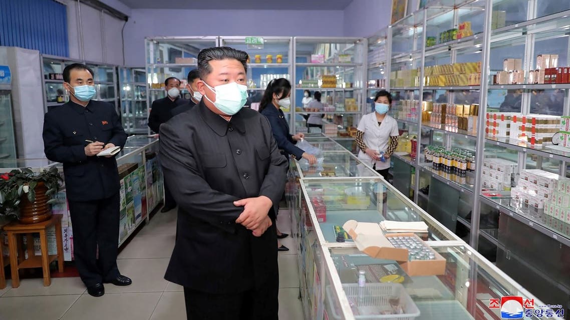 his picture taken on May 15, 2022 and released from North Korea's official Korean Central News Agency (KCNA) on May 16 shows North Korean leader Kim Jong Un (C) inspecting a pharmacy in Pyongyang. (AFP)
