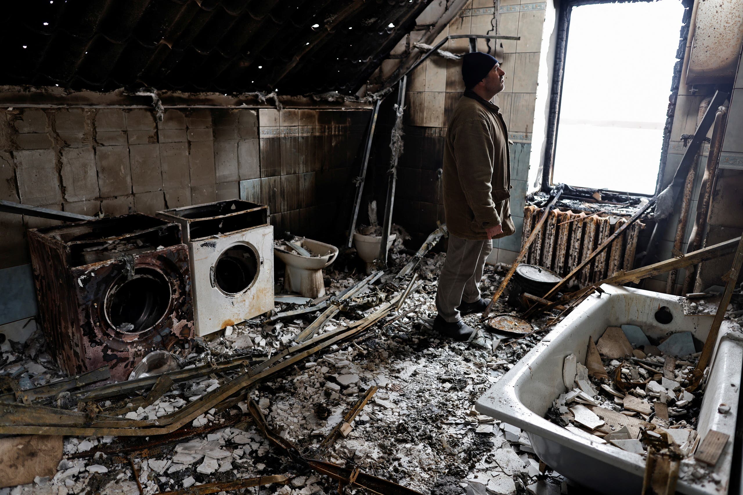 Vitalii Zhyvotovskyi, 50, stands inside his house that he told Reuters was destroyed by Russian troops as they were retreating from Bucha, in Bucha, Kyiv region, Ukraine April 19, 2022. (Reuters)