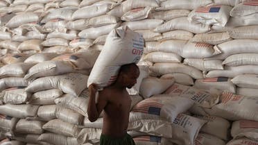 A man carries a sack of wheat at a World Food Program (WFP) warehouse, at a camp for people displaced by drought, in the town of Gode, Somali Region, Ethiopia, April 26, 2022. (Reuters)