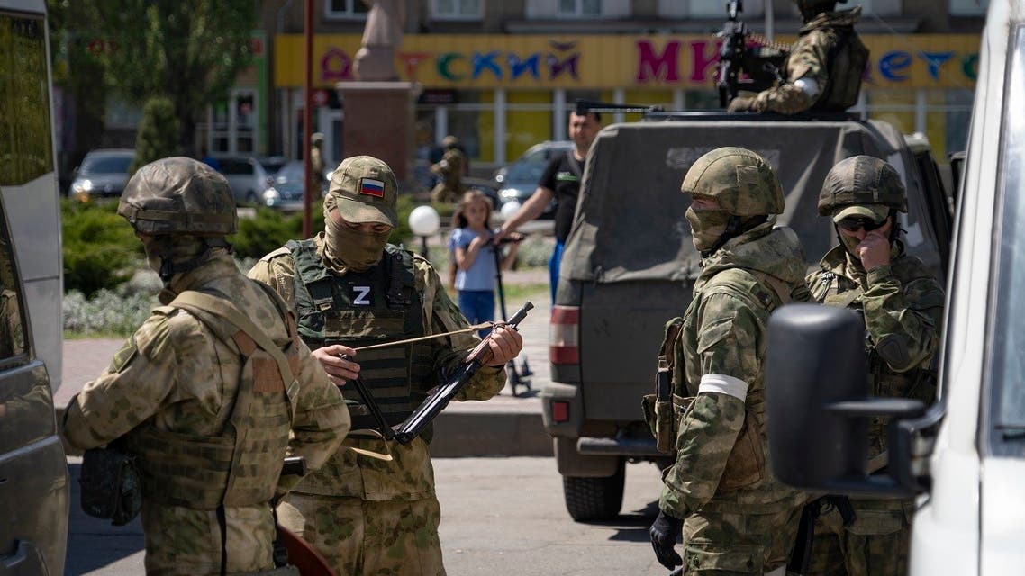 Russian servicemen patrol a street in Melitopol in Ukraine on May 1, 2022. (AFP)