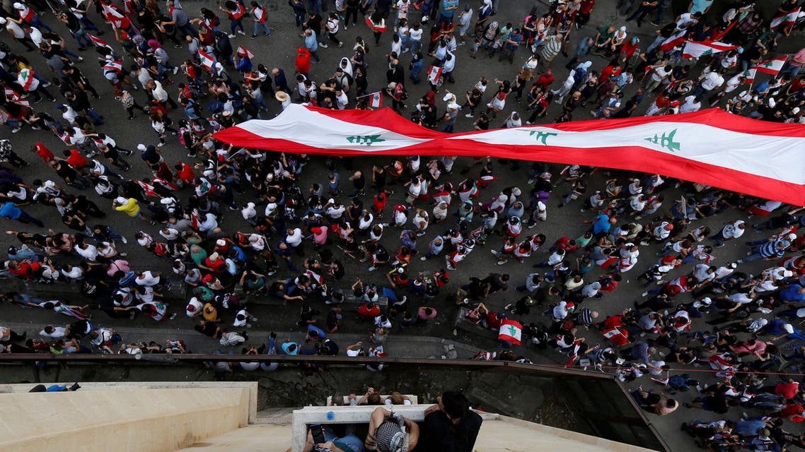 : Demonstrators carry a giant national flag during an anti-government protest in downtown Beirut, Lebanon October 20, 2019. (File Photo: Reuters)