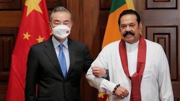 Chinese Foreign Minister Wang Yi poses for a photograph with Sri Lanka's former Prime Minister Mahinda Rajapaksa during their bilateral meeting in Colombo, Sri Lanka, January 9,2022. (File photo: Reuters)