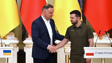 Ukrainian President Volodymyr Zelensky (R) and his Polish counterpart Andrzej Duda shake hands during a press conference following their talks in Kyiv on May 22, 2022, amid Russia's military invasion launched on Ukraine. (AFP)