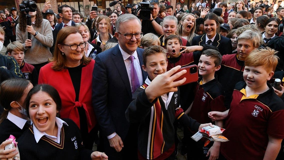 Australian Opposition Leader Anthony Albanese takes selfies with students during a visit to Cabra Dominican College as part of the federal election campaign in Adelaide, Australia, on May 20, 2022.  (Reuters)