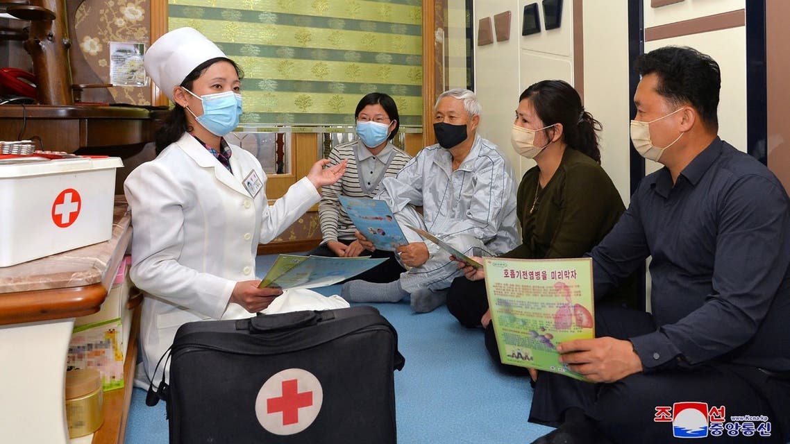 This picture taken on May 17, 2022 and released from North Korea's official Korean Central News Agency (KCNA) on May 18 shows a doctor promoting epidemic prevention measures to prevent the spread of the Covid-19 coronavirus in Pyongyang. (AFP)