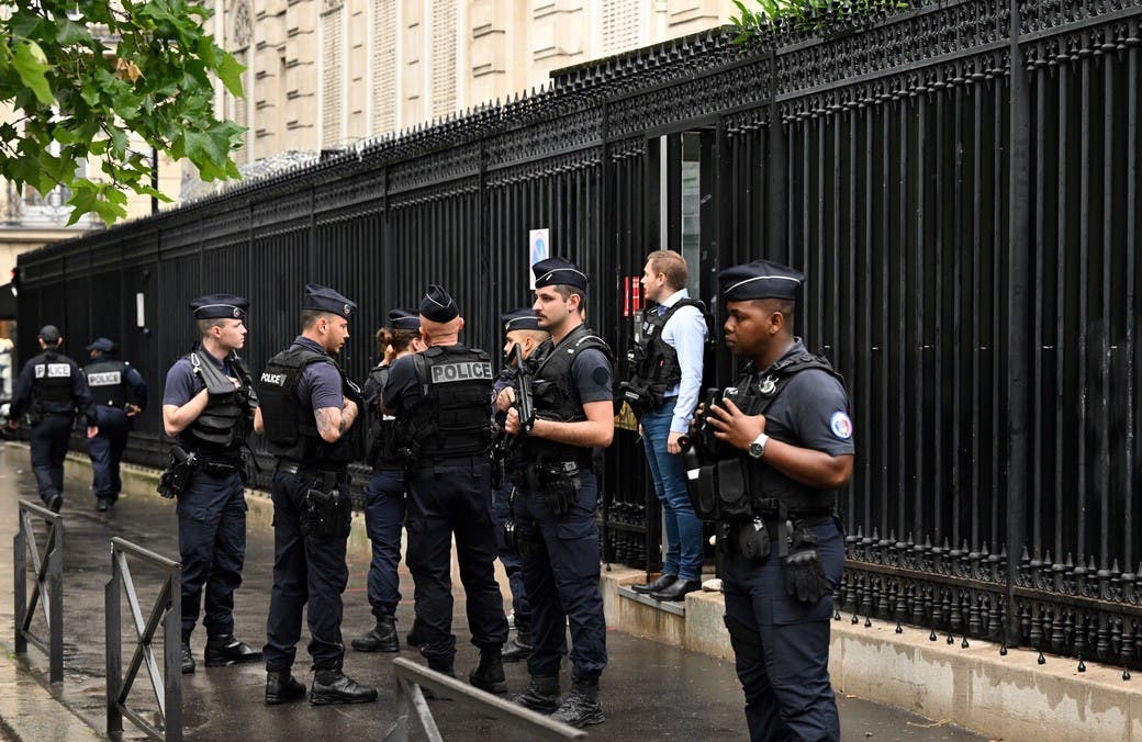 French policemen take position outside the Qatar Embassy in Paris on May 23. 2022, following an incident during which a security guard died. A guard working at the embassy of Qatar in Paris was killed by a man who was arrested afterwards, a source close to the investigation and the prosecutor of Paris told AFP. (Photo by Emmanuel DUNAND / AFP)