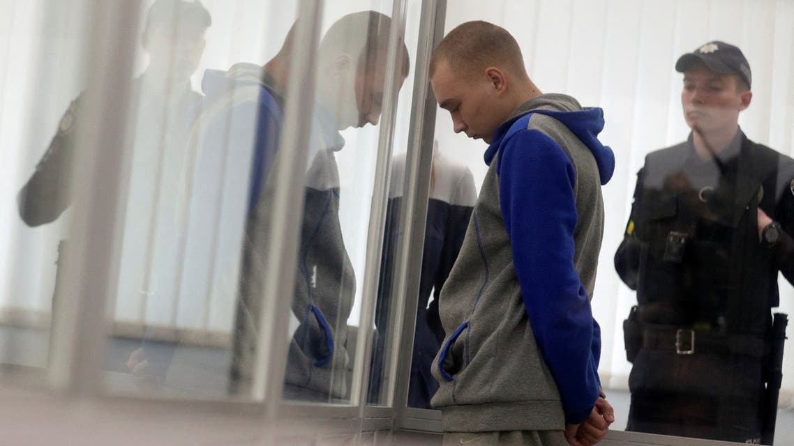 Russian soldier Vadim Shishimarin, 21, suspected of violations of the laws and norms of war, stands inside a cage during a court hearing, amid Russia's invasion of Ukraine, in Kyiv, Ukraine May 23, 2022. REUTERS/Viacheslav Ratynskyi
