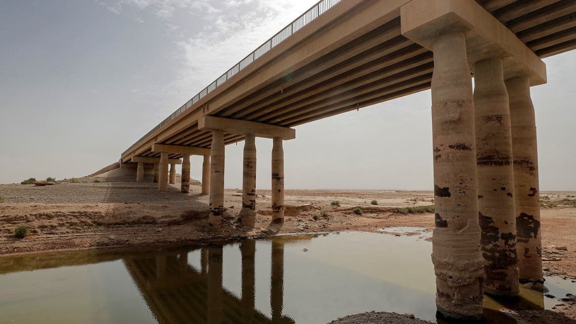 This picture taken on May 20, 2022 shows a view of a bridge and beneath the remains of Lake Hamrin in Iraq's Diyala province. (AFP)