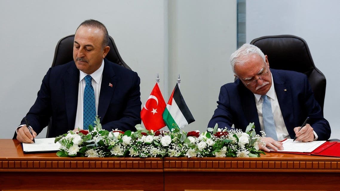 Turkish Foreign Minister Mevlut Cavusoglu and Palestinian Foreign Minister Riyad al-Maliki sign agreements during a meeting, in Ramallah, in the Israeli-occupied West Bank on May 24, 2022. (Reuters)