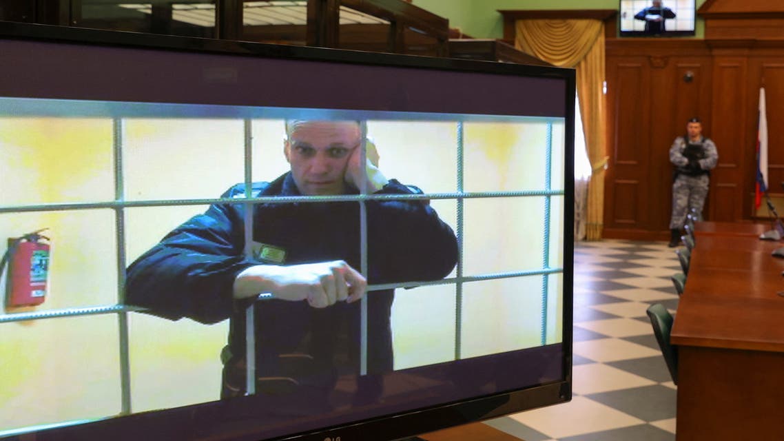 Russian opposition leader Alexei Navalny is seen on screens via a video link from the IK-2 corrective penal colony in Pokrov during a court hearing to consider an appeal against his prison sentence in Moscow, Russia May 24, 2022. (Reuters)