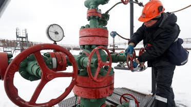 An employee turns a valve while inspecting a well head in the Yarakta Oil Field, owned by Irkutsk Oil Company (INK), in Irkutsk Region, Russia. (Reuters)