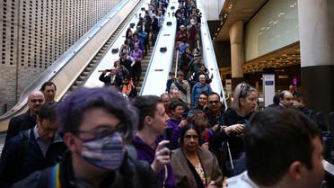 The first passengers of the Elizabeth Line at Paddington travel down an escalator into the station, on the day it opens to members of the public for the first time, in London, Britain, on May 24, 2022. (Reuters)
