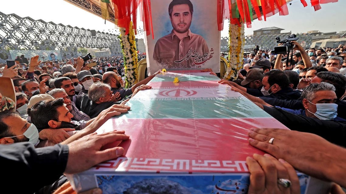 Mourners gather around the coffin of Iran's Revolutionary Guards colonel Sayyad Khodai during a funeral procession at Imam Hussein square in the capital Tehran, on May 24, 2022. Assailants on motorcycles on May 22, hit Colonel Sayyad Khodai with five bullets as he sat in his car outside his home. Iran blamed elements linked to the global arrogance -- the Islamic republic's term for its arch enemy the United States and US allies including Israel. (Photo by ATTA KENARE / AFP)