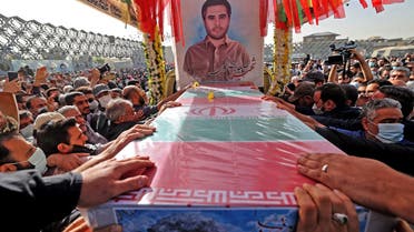 Mourners gather around the coffin of Iran's Revolutionary Guards colonel Sayyad Khodai during a funeral procession at Imam Hussein square in the capital Tehran, on May 24, 2022. Assailants on motorcycles on May 22, hit Colonel Sayyad Khodai with five bullets as he sat in his car outside his home. Iran blamed elements linked to the global arrogance -- the Islamic republic's term for its arch enemy the United States and US allies including Israel. (Photo by ATTA KENARE / AFP)