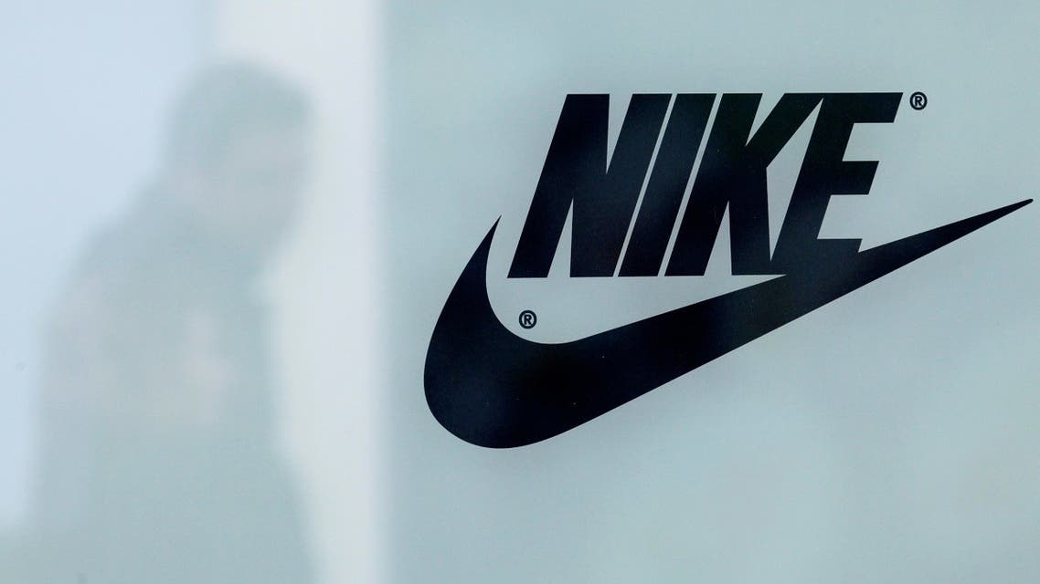 A customer is reflected in a shop window decorated with Nike store logo at the outlet village Belaya Dacha outside Moscow, Russia. (File photo: Reuters)