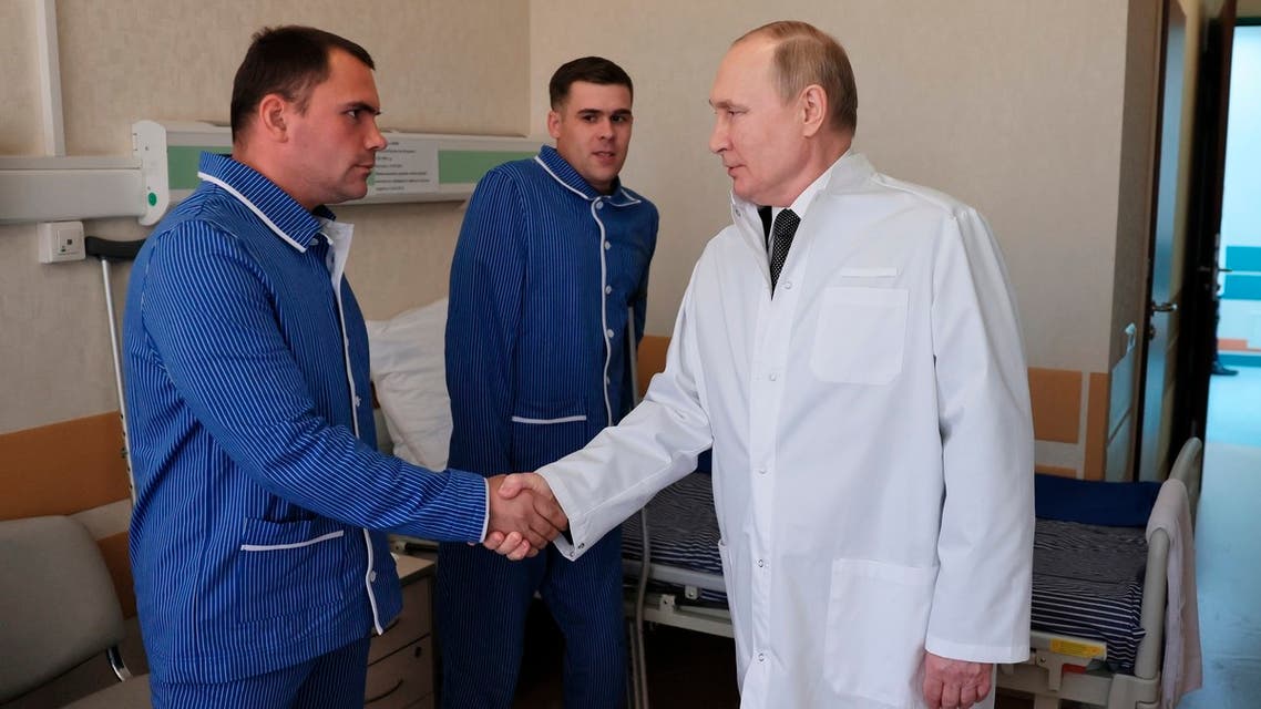 Russian President Vladimir Putin, right, meets with Pvt. Anatoly Shpakov, left, and Pvt. Vladislav Chendylov at the Central Military Clinical Hospital in Moscow, Russia, Wednesday, May 25, 2022. Shpakov and Vladislav Chendylov were wounded during Russia's military operation in Ukraine. (Mikhail Metzel, Sputnik, Kremlin Pool Photo via AP)