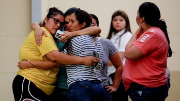 People react outside the Ssgt Willie de Leon Civic Center, where students had been transported from Robb Elementary School after a shooting, in Uvalde, Texas, U.S. May 24, 2022. REUTERS/Marco Bello REFILE - QUALITY REPEAT