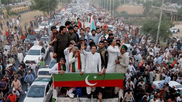 Ousted Pakistani Prime Minister Imran Khan gestures as he travels on a vehicle to lead a protest march in Islamabad, Pakistan, on May 26, 2022. (Reuters)