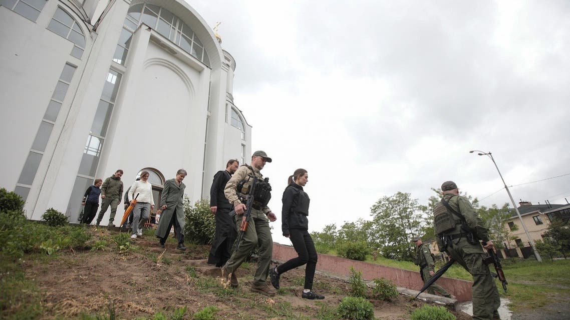 Finland's PM Sanna Marin visits a church where a mass grave was found after Russian troops retreated from the town of Bucha, May 26, 2022. (Reuters)