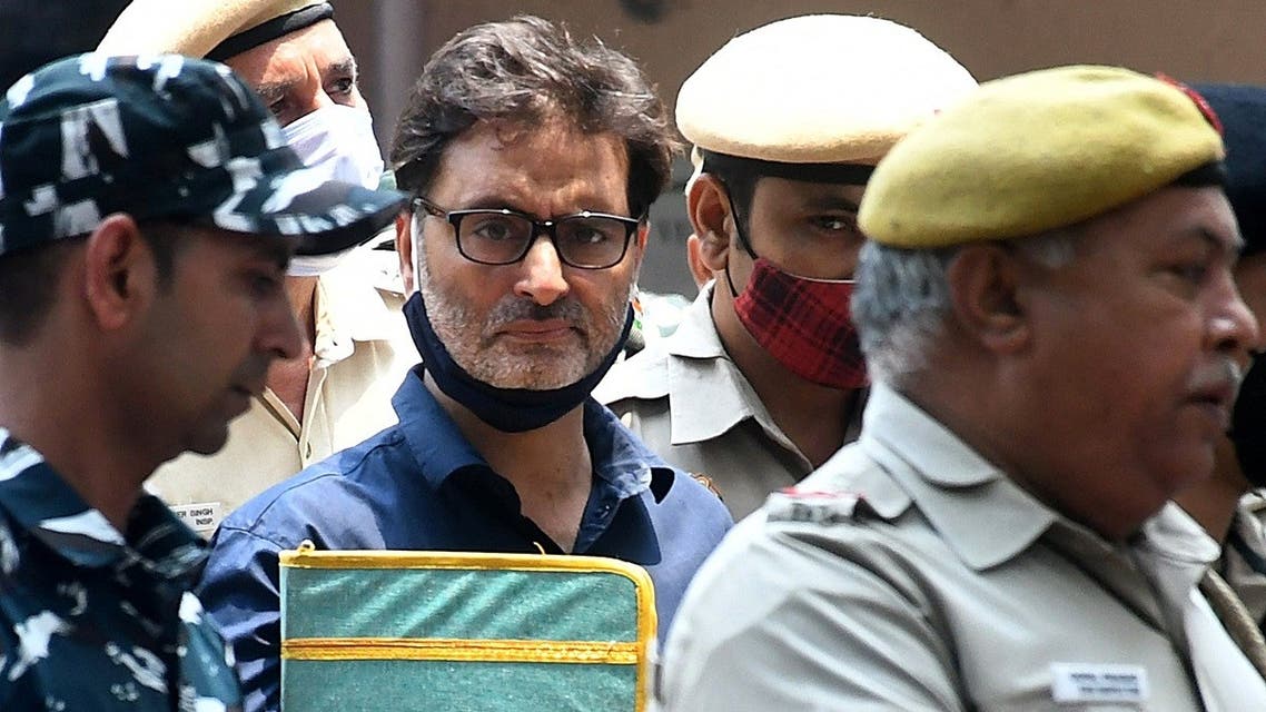 Yasin Malik, chairman of Jammu Kashmir Liberation Front (JKLF), a separatist party, is escorted by Indian police officers at a court premises in New Delhi, India, on May 25, 2022. (Reuters)