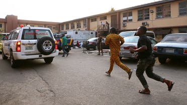 A file photo shows men rush towards an ambulance outside a hospital after a building containing a school collapsed in Nigeria's commercial capital Lagos, Nigeria March 13, 2019. (Reuters)
