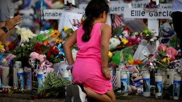 A girl pays respects at the memorial at Robb Elementary school, where a gunman killed 19 children and two adults, in Uvalde, Texas, U.S. May 28, 2022. REUTERS/Marco Bello TPX IMAGES OF THE DAY
