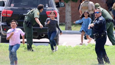 Children run to safety after escaping from a window during a mass shooting at Robb Elementary School where a gunman killed nineteen children and two adults in Uvalde, Texas, U.S. May 24, 2022. (Reuters)
