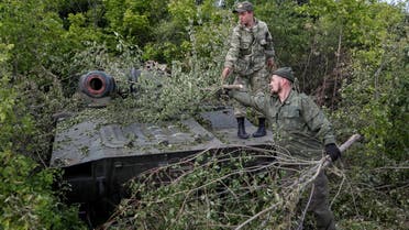 Service members of pro-Russian troops remove branches covering a self-propelled howitzer 2S1 Gvozdika at their combat positions in the Luhansk region, Ukraine May 24, 2022. REUTERS/Alexander Ermochenko
