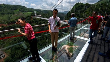 People walk on the Bach Long glass bridge during the opening ceremony at Moc Chau district in Son La province, Vietnam, May 28, 2022. Picture taken on May 28, 2022. (Reuters)