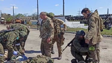 In this photo taken from video released by the Russian Defense Ministry on Friday, May 20, 2022, Russian servicemen frisk Ukrainian servicemen after they leaved the besieged Azovstal steel plant in Mariupol, in territory under the government of the Donetsk People's Republic, eastern Ukraine. (Russian Defense Ministry Press Service via AP)