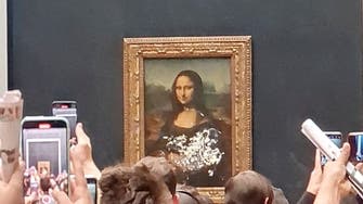Mona Lisa smeared in cream in climate protest stunt, but left unharmed