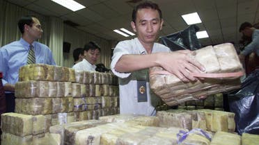 Thai authorities unload a haul of drugs siezed in a January 7 raid on fishing boats off southern Thailand, shown to the press in Bangkok on January 9, 2001. (Reuters)