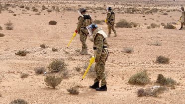 Members of the military engineering team dismantle mines in Abu Grein, Libya on March 13, 2021. (Reuters)