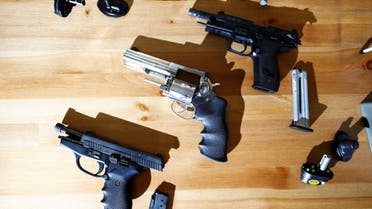 Three legally-owned hand guns are displayed on a gun owner's table after Canada's government introduced legislation to implement a national freeze on the sale and purchase of handguns, as a part of a gun control package that would also limit magazine capacities and ban some toys that look like guns, in New Westminster, British Columbia, Canada May 30, 2022. (Reuters)