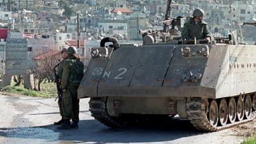 An Israeli armoured personnel carrier is stationed at an entrance to the Al Aroub refugee camp in the West Bank, near Bethlehem February 12, 2001. Israel has deployed heavy armour into the West Bank underlining heightened tension following an increase of violence in the week since right-wing hawk Ariel Sharon won in an election over his opponent, Ehud Barak. (Reuters)