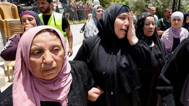 Relatives of a Palestinian woman, who was killed by the Israeli army, react during her funeral in al-Arroub refugee camp near Hebron in the Israeli-occupied West Bank, June 1, 2022. (Reuters)