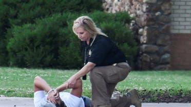 A police officer consoles a person at the family reunion location, Memorial High School, after a shooting at the Saint Francis hospital campus, in Tulsa, Oklahoma, June 1, 2022. REUTERS/Michael Noble Jr.