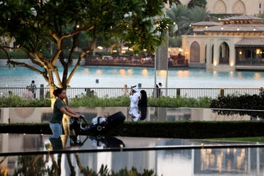 People visit a park the Burj Khalifa tower in the Gulf Emirate of Dubai on May 27, 2022. (File photo: AFP)