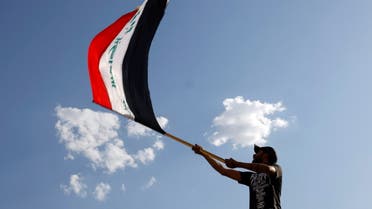 A demonstrator waves an Iraqi flag during an anti-government protest in Baghdad, Iraq May 25, 2021. REUTERS/Thaier Al-Sudani