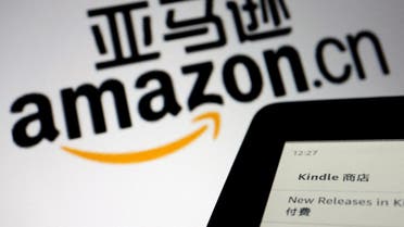 The sign of e-commerce website Amazon China is seen next to a Kindle e-reader displayed in this illustration. (Reuters)